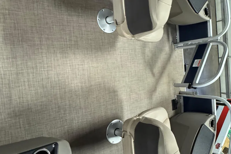 Slide: The Image of 2025 Sun Tracker Bass Buggy 18 DLX interior with beige seating and flooring. - 12