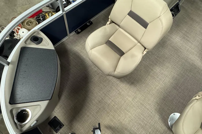 Slide: The Image of 2025 Sun Tracker Bass Buggy 18 DLX interior with beige seating and control panel. - 5