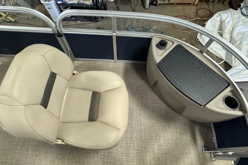 Slide: The Image of 2025 Sun Tracker Bass Buggy 18 DLX interior with beige seating and control panel. - 6