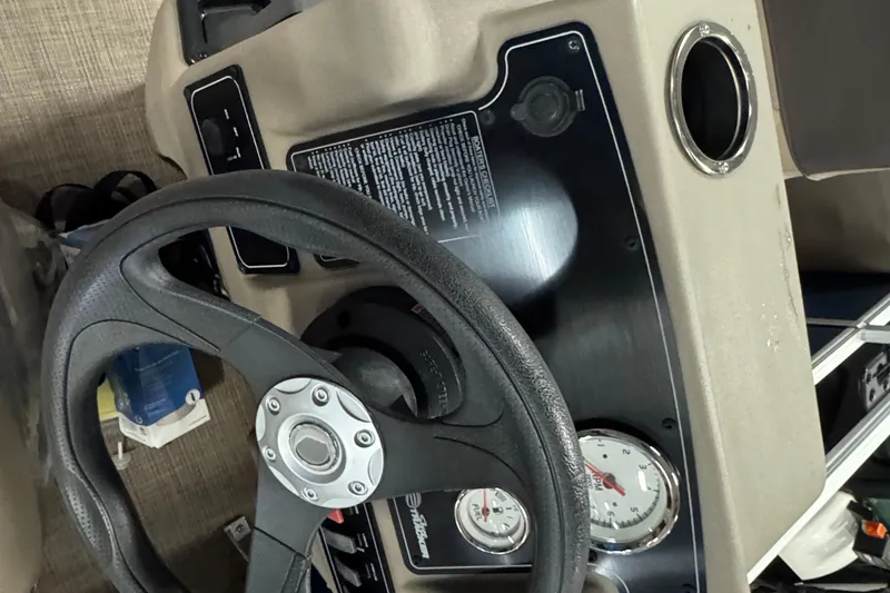 Slide: The Image of Steering console of 2025 Sun Tracker Bass Buggy 18 DLX with gauges and controls. - 9