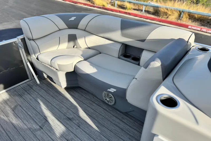 Slide: The Image of 2019 Starcraft EX 20 C boat interior with gray seating and cup holders. - 11
