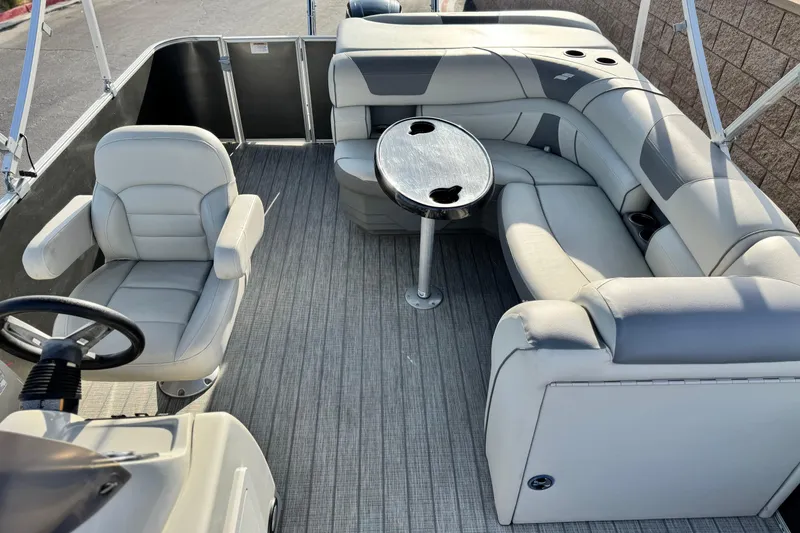 Slide: The Image of 2019 Starcraft EX 20 C pontoon boat interior with seating and table. - 12