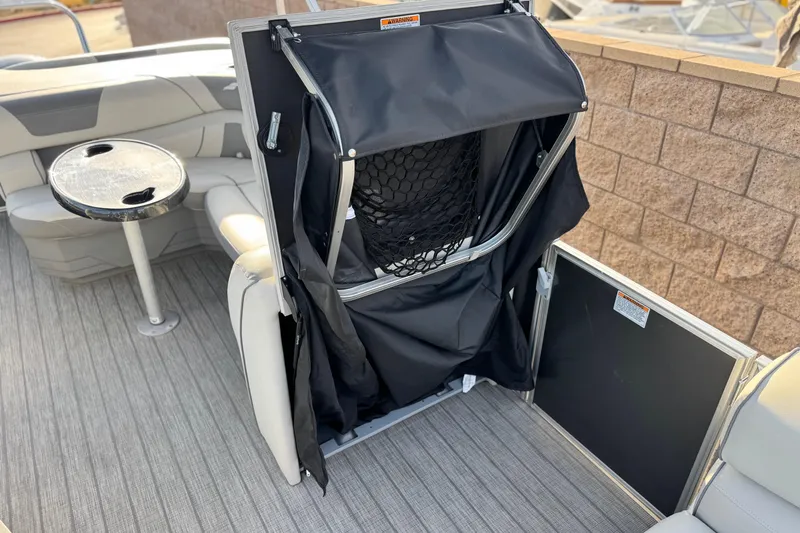 Slide: The Image of 2019 Starcraft EX 20 C boat interior with seating, table, and storage compartment. - 14