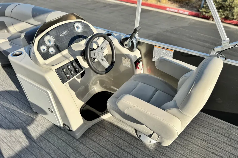 Slide: The Image of 2019 Starcraft EX 20 C boat interior with steering wheel and captain's chair. - 21