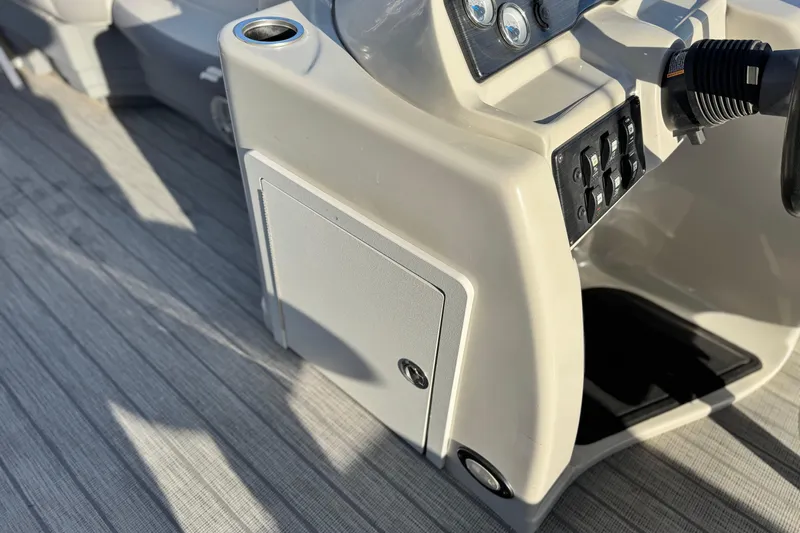 Slide: The Image of 2019 Starcraft EX 20 C boat console with controls and cup holder. - 23