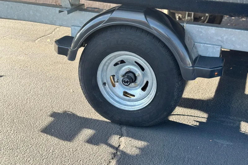 Slide: The Image of Trailer wheel of a 2019 Starcraft EX 20 C on asphalt surface. - 24