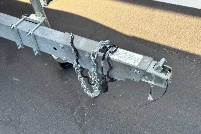 Slide: The Image of Trailer hitch of a 2019 Starcraft EX 20 C with safety chains and wiring. - 25