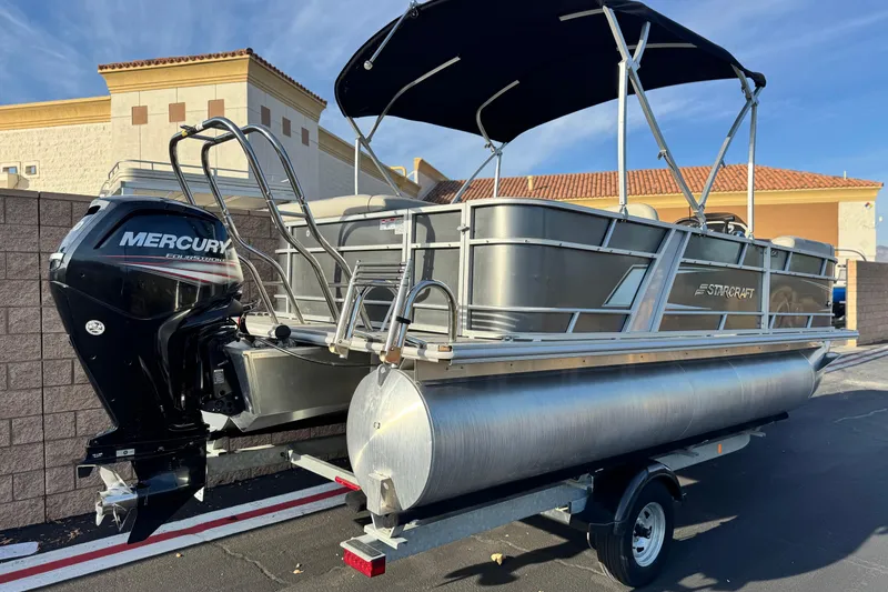 Slide: The Image of 2019 Starcraft EX 20 C pontoon boat with Mercury outboard engine on trailer. - 6
