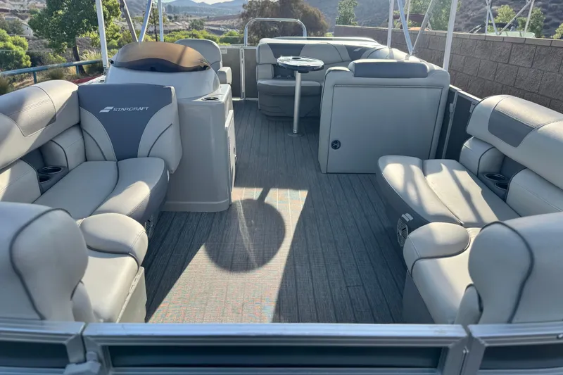 Slide: The Image of 2019 Starcraft EX 20 C pontoon boat interior with spacious seating and modern design. - 8