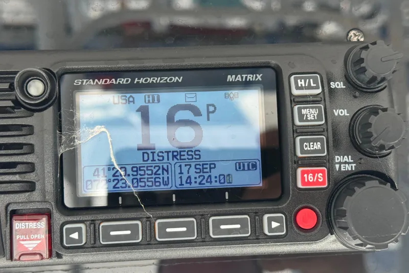 Slide: The Image of Standard Horizon Matrix radio displaying distress signal coordinates on Edgewater 320CC, 2016 model. - 15