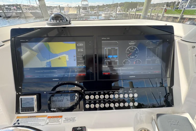 Slide: The Image of Edgewater 320CC 2016 boat dashboard with dual Garmin displays and navigation controls. - 17