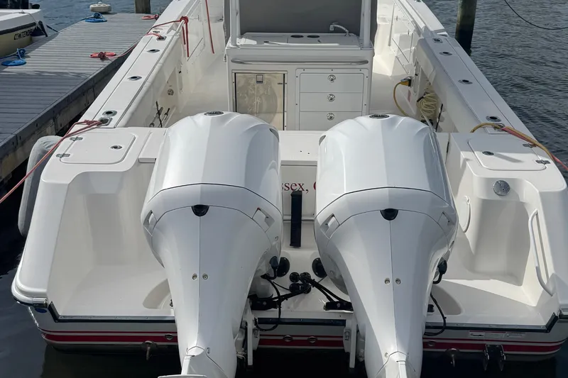Slide: The Image of 2016 Edgewater 320CC boat with dual outboard engines docked at a marina. - 3
