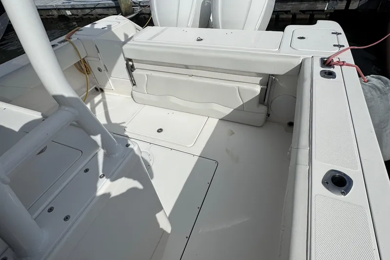Slide: The Image of 2016 Edgewater 320CC boat interior with seating and storage compartments. - 7