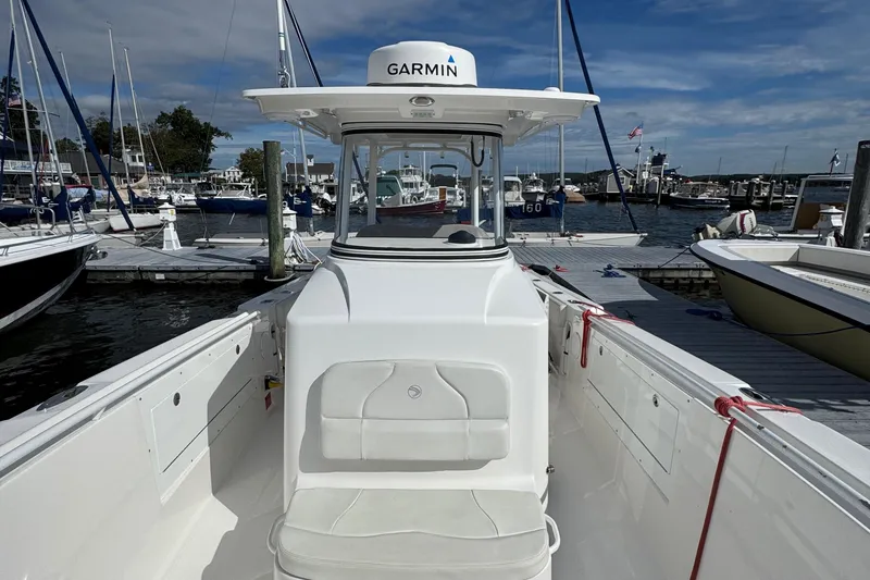 Slide: The Image of 2016 Edgewater 320CC boat docked at marina with Garmin equipment. - 9