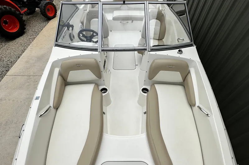 Slide: The Image of 2019 Stingray 191 DC boat interior with beige seating and steering wheel. - 10