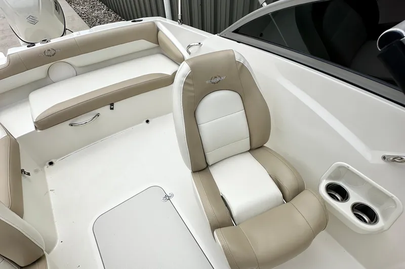 Slide: The Image of 2019 Stingray 191 DC boat interior with beige and white seating. - 13