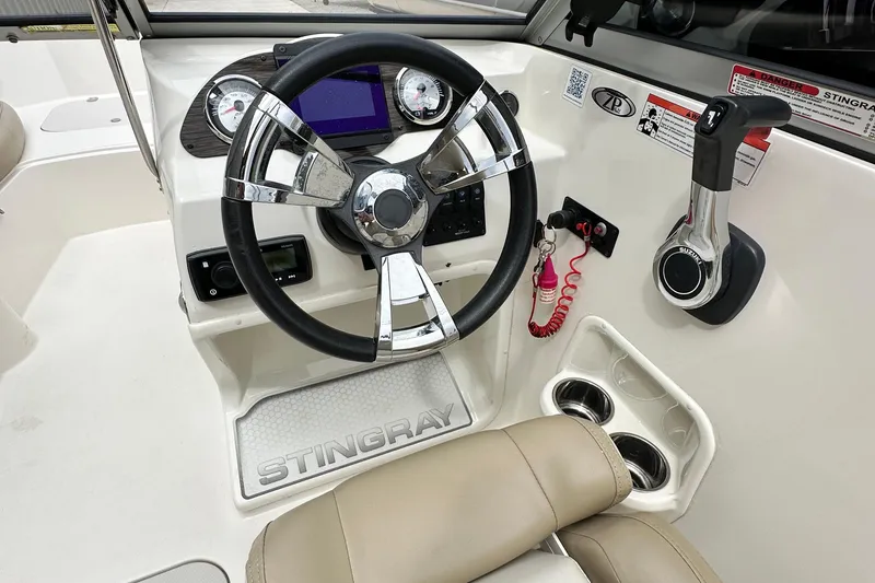 Slide: The Image of 2019 Stingray 191 DC boat dashboard with steering wheel and controls. - 15