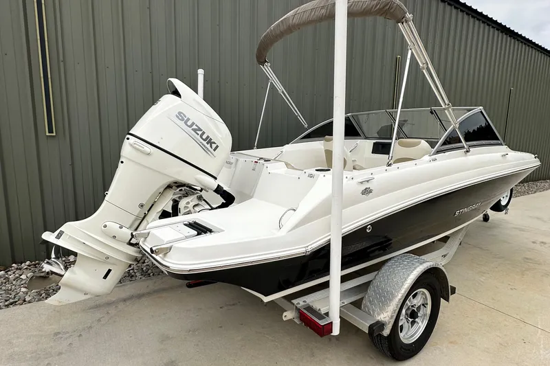 Slide: The Image of 2019 Stingray 191 DC boat with Suzuki outboard motor on trailer. - 6