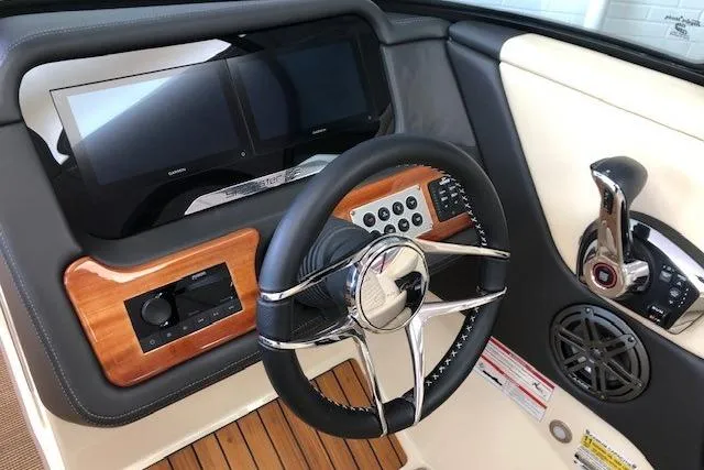 Slide: The Image of 2025 Chris-Craft Sportster 25 dashboard with steering wheel, controls, and dual screens. - 13