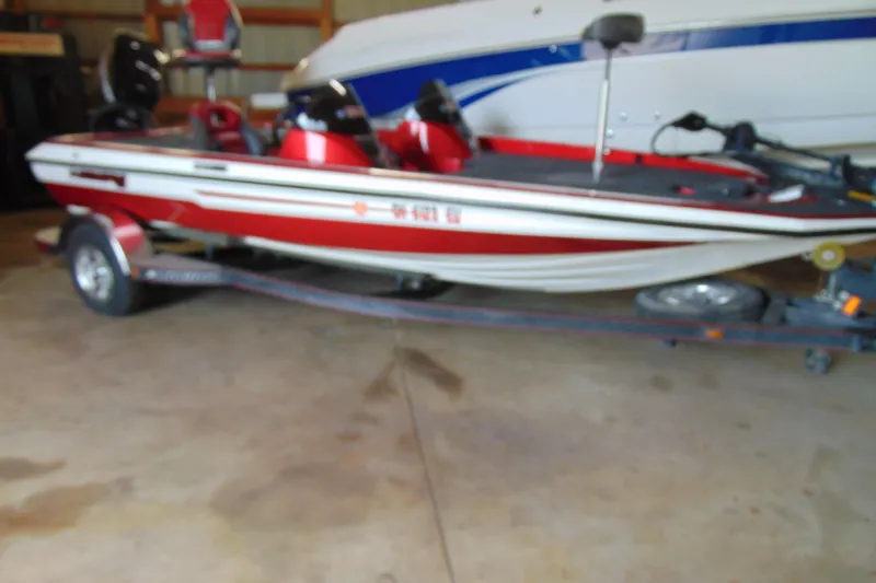 The Image of 2011 Stratos 183 Elite red and white boat on trailer in garage. - 1