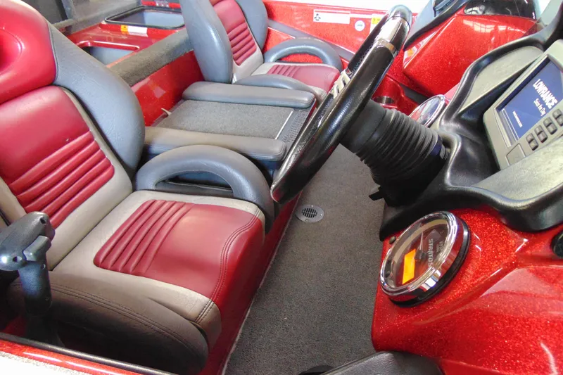 Slide: The Image of 2011 Stratos 183 Elite boat interior with red and gray seating, steering wheel, and dashboard. - 12