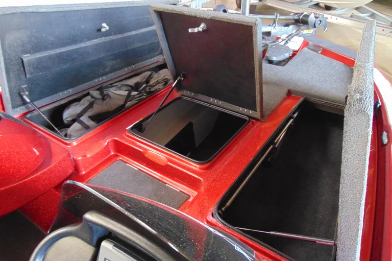 Slide: The Image of 2011 Stratos 183 Elite boat with open storage compartments and red finish. - 18