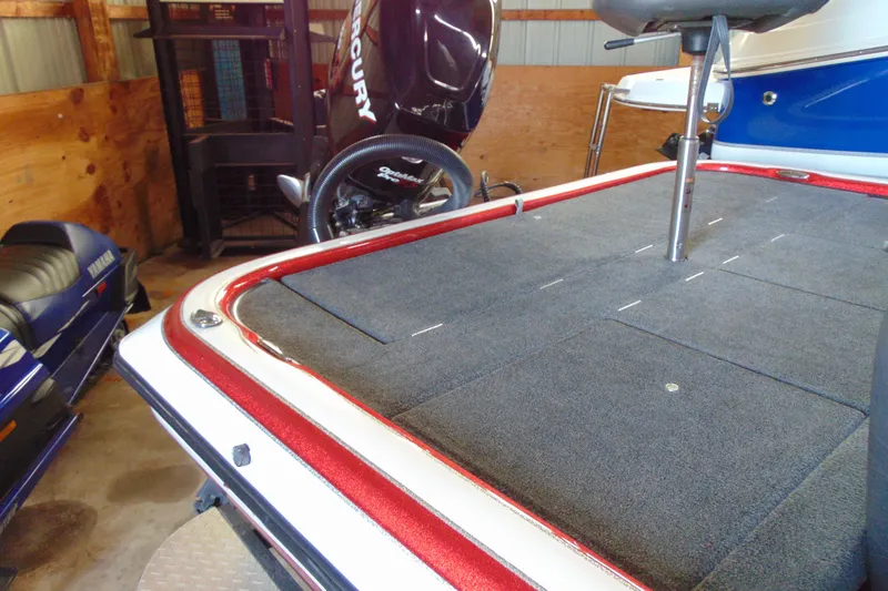 Slide: The Image of 2011 Stratos 183 Elite boat with Mercury engine in a garage setting. - 4