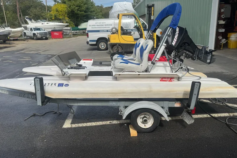 Slide: The Image of 2009 CraigCat custom boat on trailer with Mercury engine at marina. - 4