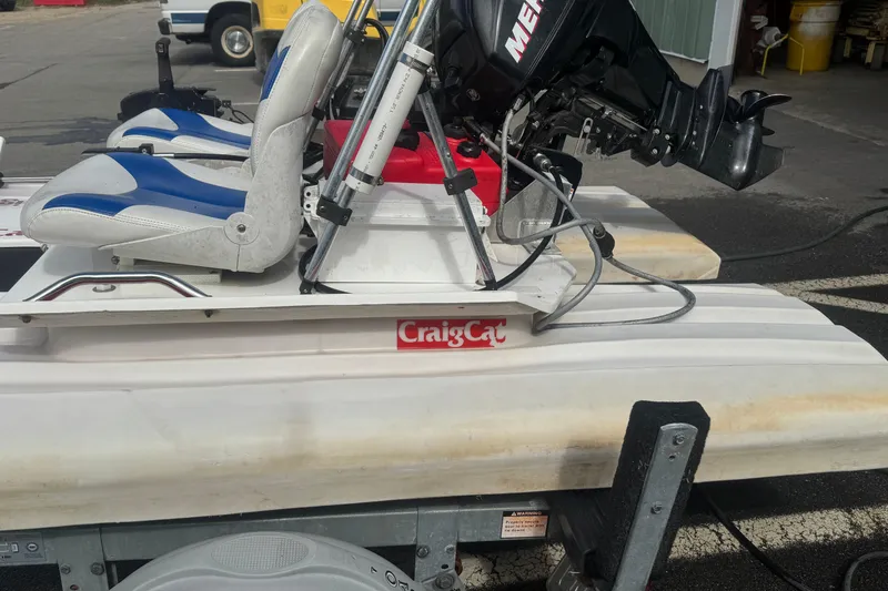 Slide: The Image of 2009 CraigCat custom boat with blue and white seats and Mercury motor. - 5