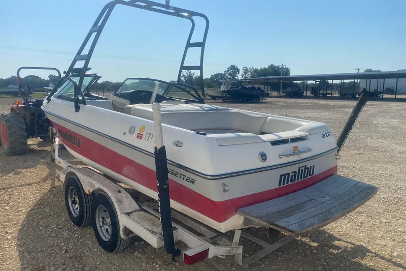 Slide: The Image of 2003 Malibu Sunsetter 21 XTi boat on trailer in outdoor setting. - 3