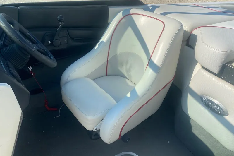 Slide: The Image of 2003 Malibu Sunsetter 21 XTi boat interior with white seating and steering wheel. - 6