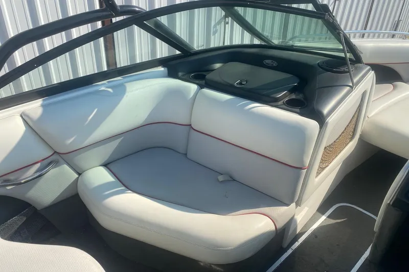 Slide: The Image of 2003 Malibu Sunsetter 21 XTi boat interior with white seating and black accents. - 7