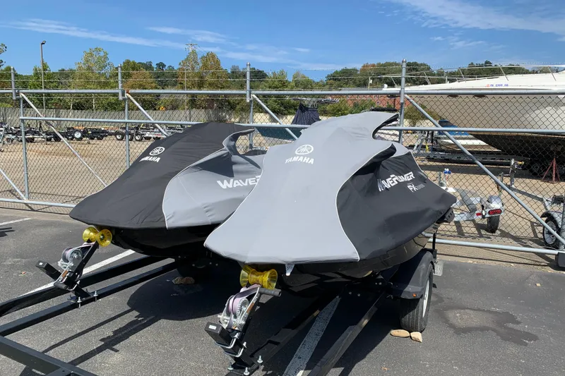 Slide: The Image of 2018 Yamaha WaveRunner FX Cruiser HO jet skis covered, parked on trailers in a lot. - 10
