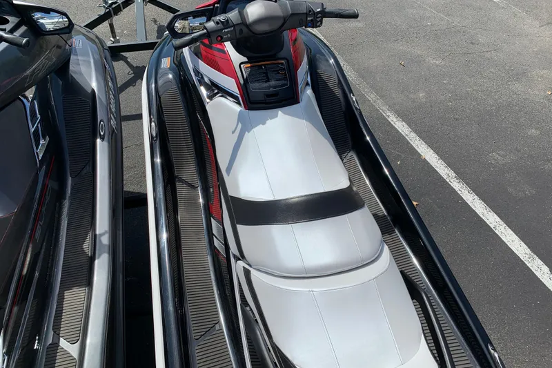 Slide: The Image of 2018 Yamaha WaveRunner FX Cruiser HO, white and red, parked on asphalt. - 7