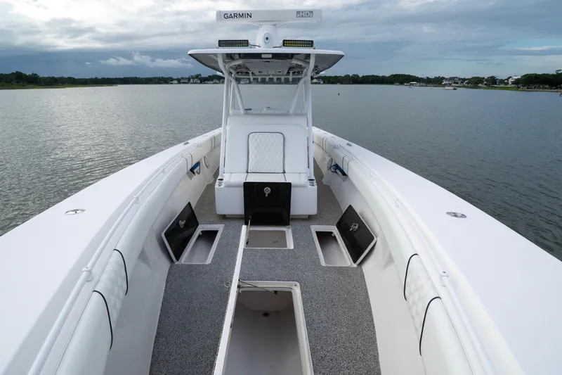 Slide: The Image of 2012 SeaHunter 37 Tournament boat on calm water, featuring spacious deck and storage compartments. - 10