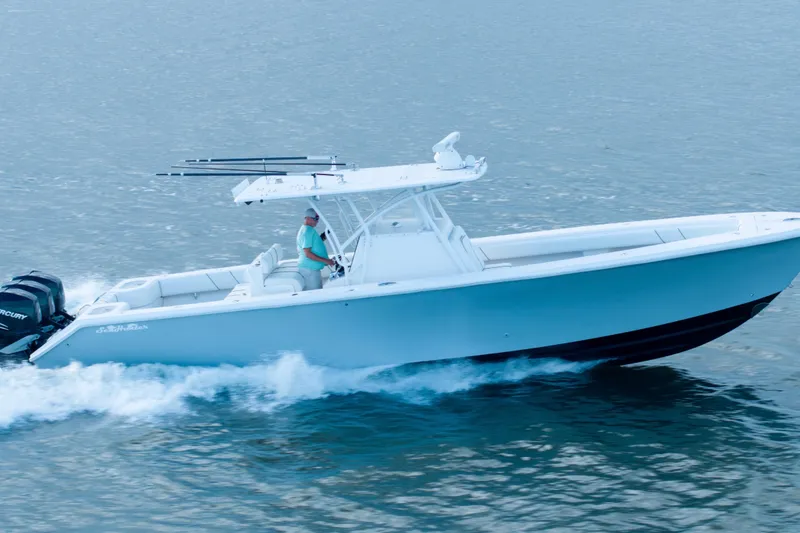 Slide: The Image of 2012 SeaHunter 37 Tournament boat cruising on water, side view. - 5