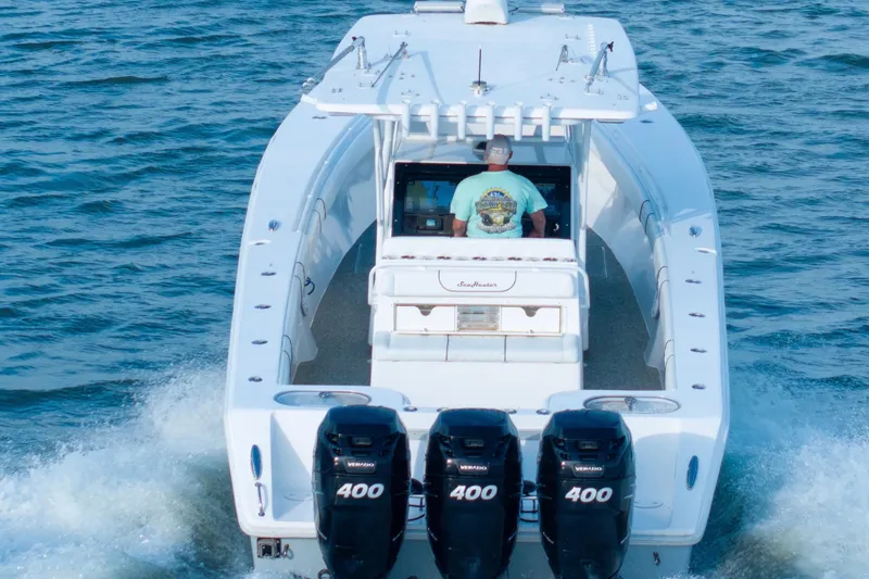 Slide: The Image of 2012 SeaHunter 37 Tournament boat cruising on open water, rear view. - 7