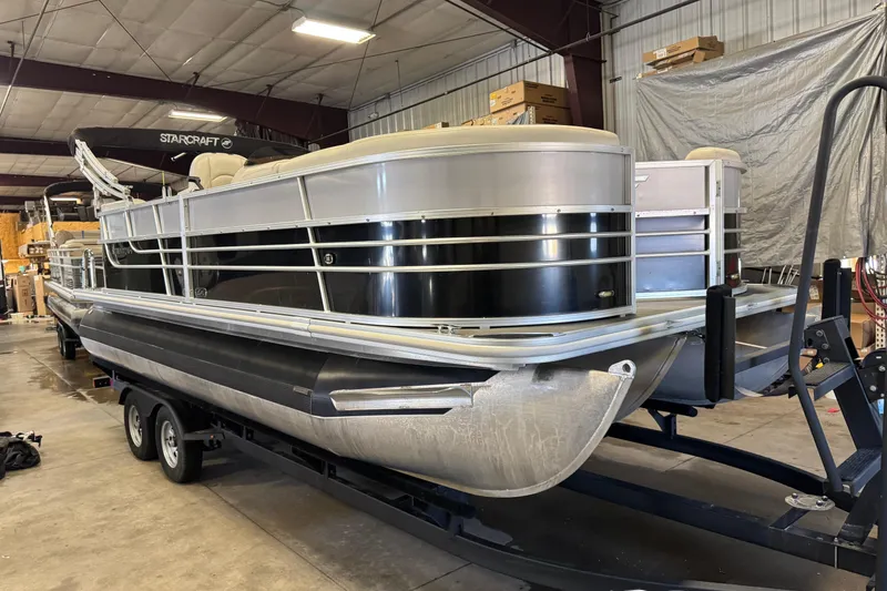 Slide: The Image of 2017 Starcraft EX 21 R pontoon boat on trailer in indoor storage. - 2
