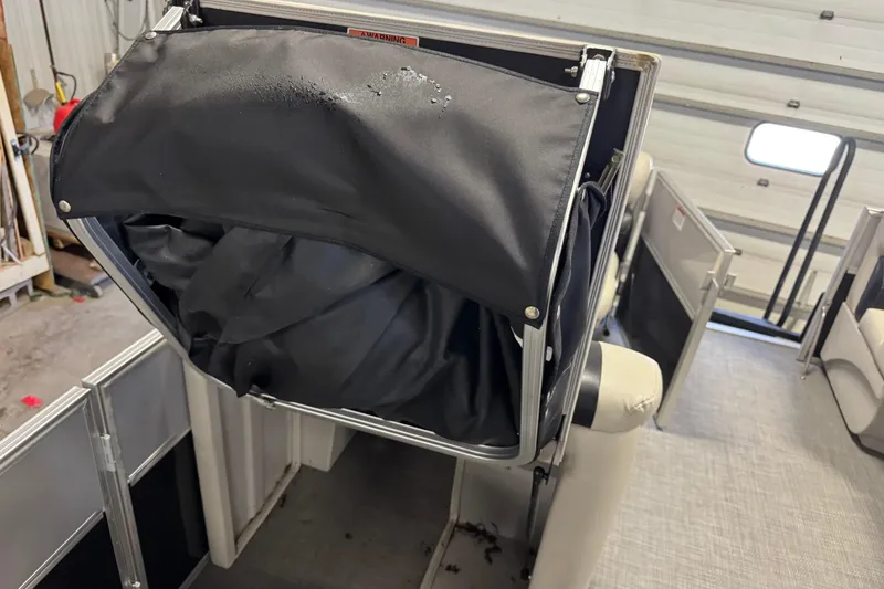 Slide: The Image of 2017 Starcraft EX 21 R boat interior with black storage compartment. - 20