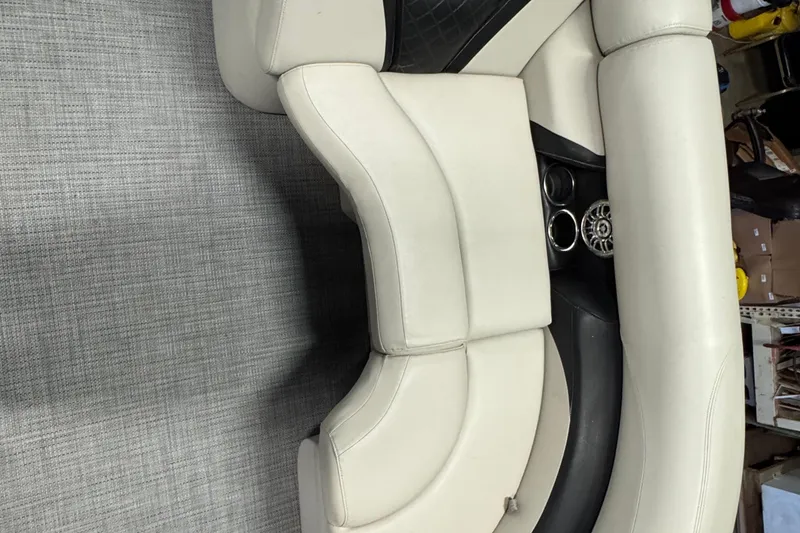 Slide: The Image of 2017 Starcraft EX 21 R boat interior with beige seating and cup holders. - 6