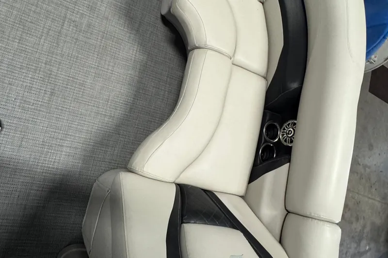 Slide: The Image of White and black seating on 2017 Starcraft EX 21 R boat, featuring cup holders. - 7