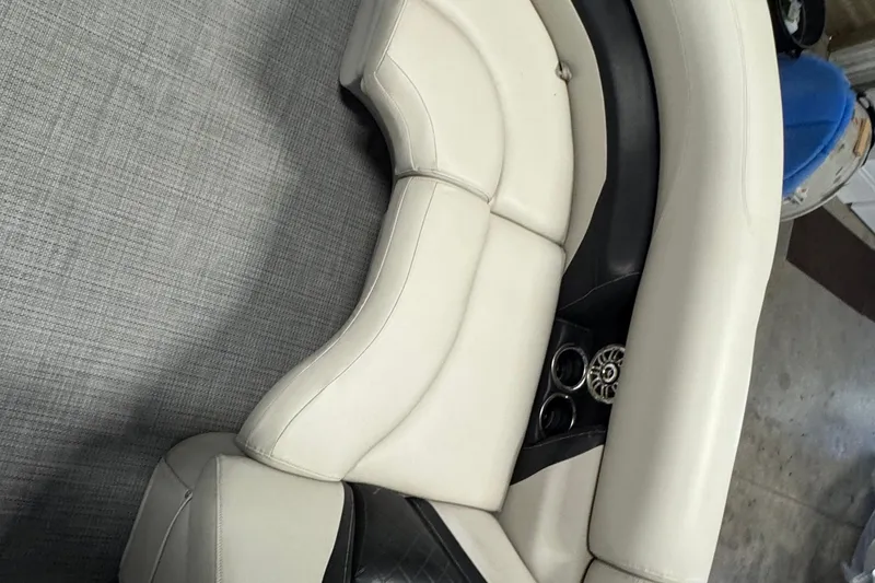 Slide: The Image of 2017 Starcraft EX 21 R boat interior with beige seating and cup holders. - 8