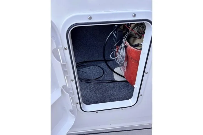 Slide: The Image of Open hatch on 2013 Yamaha AR192 boat showing interior wiring and equipment. - 10
