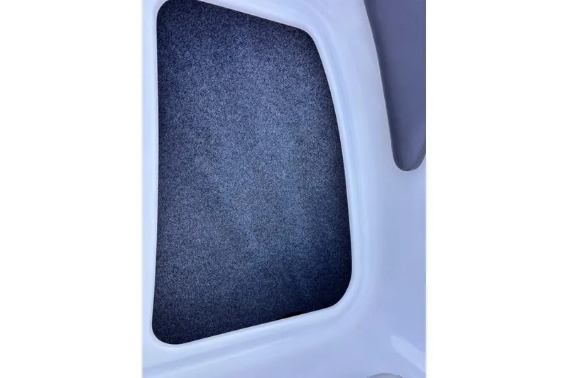 Slide: The Image of Interior view of a 2013 Yamaha AR192 boat, featuring a carpeted compartment. - 11