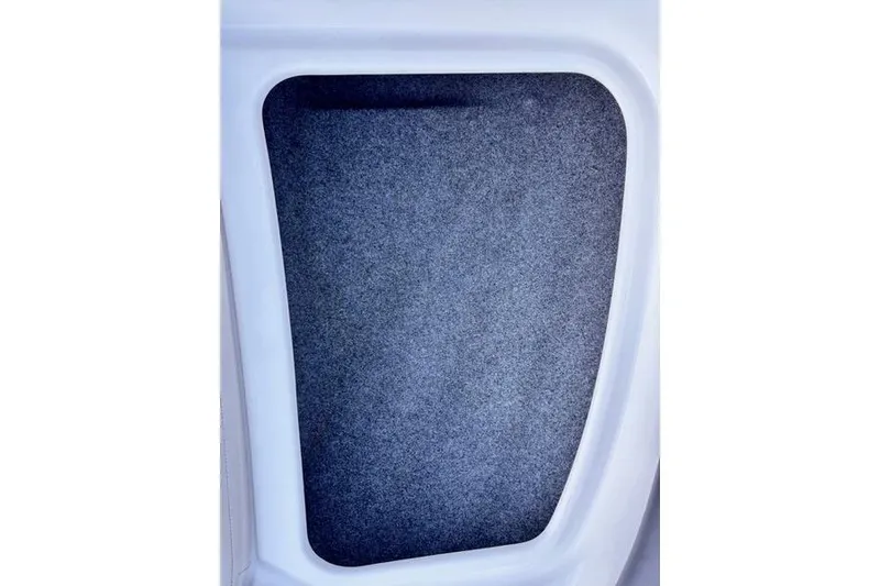 Slide: The Image of Interior storage compartment of 2013 Yamaha AR192 boat, featuring a carpeted surface. - 12
