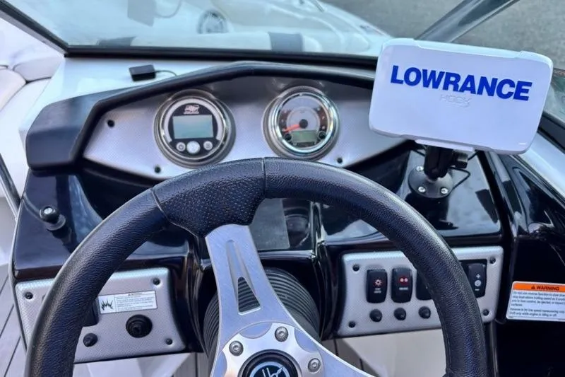 Slide: The Image of 2013 Yamaha AR192 boat dashboard with steering wheel and Lowrance GPS system. - 15