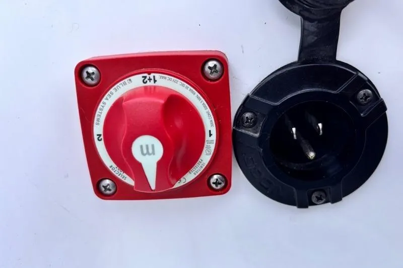 Slide: The Image of Red battery switch and black socket on 2013 Yamaha AR192 boat. - 24