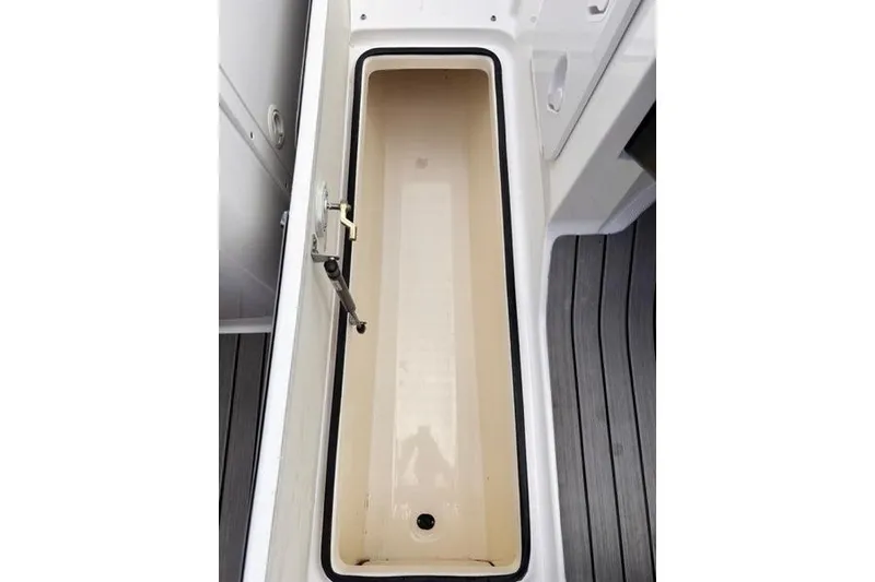 Slide: The Image of 2013 Yamaha AR192 boat storage compartment with open lid, showcasing interior space. - 27