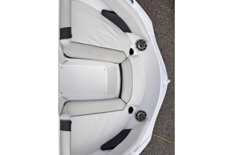 Slide: The Image of 2013 Yamaha Boats AR192 interior with white cushioned seating and built-in speakers. - 28