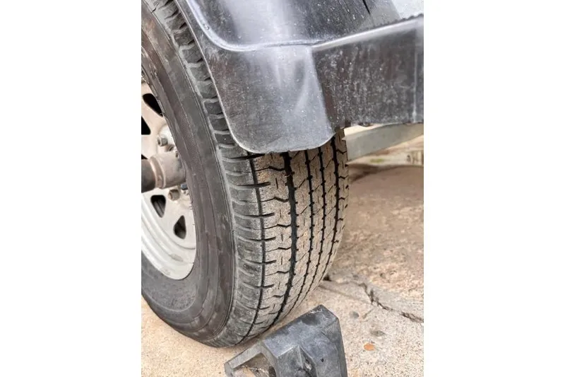 Slide: The Image of Close-up of a 2013 Yamaha Boats AR192 trailer tire on pavement. - 34